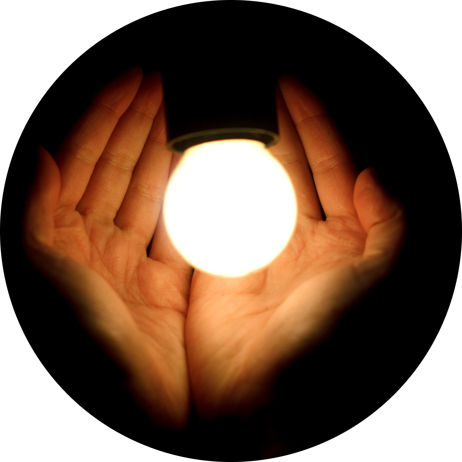 Hands holding an illuminated sphere